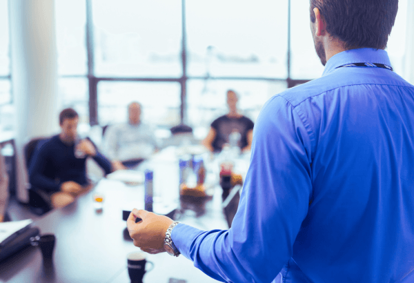 Business professionals shaking hands, representing headhunting services for SMEs and startups to fill management positions.